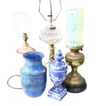 A brass oil lamp, with an unassociated yellow vaseline glass shade, another oil lamp with glass