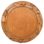 A 20th century turned wood bread board, with applied leaf decoration, diameter 29cm