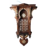 A Moorish design carved and pierced wood hanging shrine, mother-of-pearl bone and ebony inlaid,