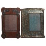An Art Nouveau embossed copper-mounted photo frame, and a 1920s oak photo frame with applied