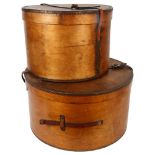 A graduated pair of early 20th century bent ply hat boxes, with leather handles, largest diameter