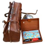 A framed Chinese silk sleeve, a leather suitcase, coins and a games compendium