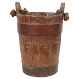 A 19th century coopered oak fire bucket with rope handle, diameter 24cm, height 37.5cm