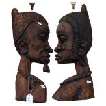 A pair of African carved profile wall hangings, L60cm