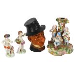 A pair of Naples porcelain figures, a Continental group of children, and a novelty painted pottery