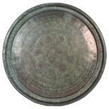 A large Persian tin tray with engraved decoration, diameter 67.5cm