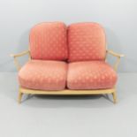 A mid-century Ercol Windsor 203 beech two-seater sofa in Golden Dawn finish, with blue maker's