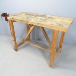 A homemade pine workbench with small fitted vice. 122x84x59cm.