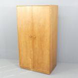 A mid-century Meredew light oak veneered two door wardrobe, with maker's label. 91x172x57cm.