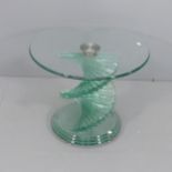 A contemporary circular glass-topped occasional table on stepped spiral base, in the manner of Danny