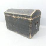A Victorian leather-covered dome top trunk. 70x50x42cm. Top is split down length. Various marks,