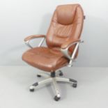 A mid-century style chrome and brown faux-leather upholstered swivel desk chair, with label for