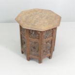 An Anglo-Indian hardwood octagonal occasional table, on folding base with carved and inlaid