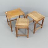 A nest of three Ugandan hardwood occasional tables, with carved decoration and the smallest having