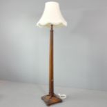 A 1920s oak standard lamp, with platform base. Height to bayonet 160cm.