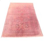 An antique red-ground bokhara rug, 234cmx137cm.