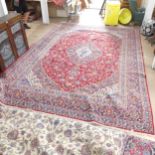 A red-ground Tabriz carpet. 435x306cm. Good overall condition.
