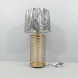 A contemporary table lamp and shade, with a pierced open latticework body, overall height 73cm