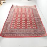 A red-ground Tekki rug. 225x158cm.