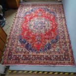 A red-ground Meshed carpet. 330x240cm.
