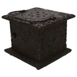 18th century oak carriage foot-warming stool, chip carved decoration allover with iron swing handle,