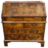 An early 18th century walnut bureau, with stepped fitted interior, 2 short and 2 long drawers
