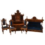 A set of early 20th century oak dolls furniture, dresser, upholstered sofa and two chairs, dresser