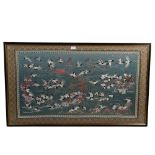 A Chinese silk embroidered picture, depicting storks on a lake, machine embroidered surround,