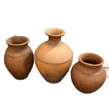 3 large Portuguese weathered terracotta olive jars, impressed makers mark to two smaller jars,