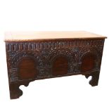 An 18th century carved walnut coffer, width 118cm, depth 52cm, height 68 cm 10 inch crack in top,