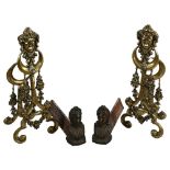 A pair of cast-brass fireplace chenets with mask decorations, height 58cm, and a pair of bronze