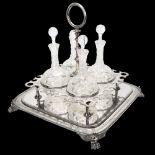 A 19th century electroplate drinks stand holding 4 cut-glass decanters, the stand having an engraved