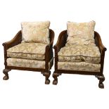 A pair of good quality walnut framed bergere tub chairs, circa 1900, with double cane panels, relief