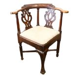 An 18th century ash corner armchair with drop-in seat