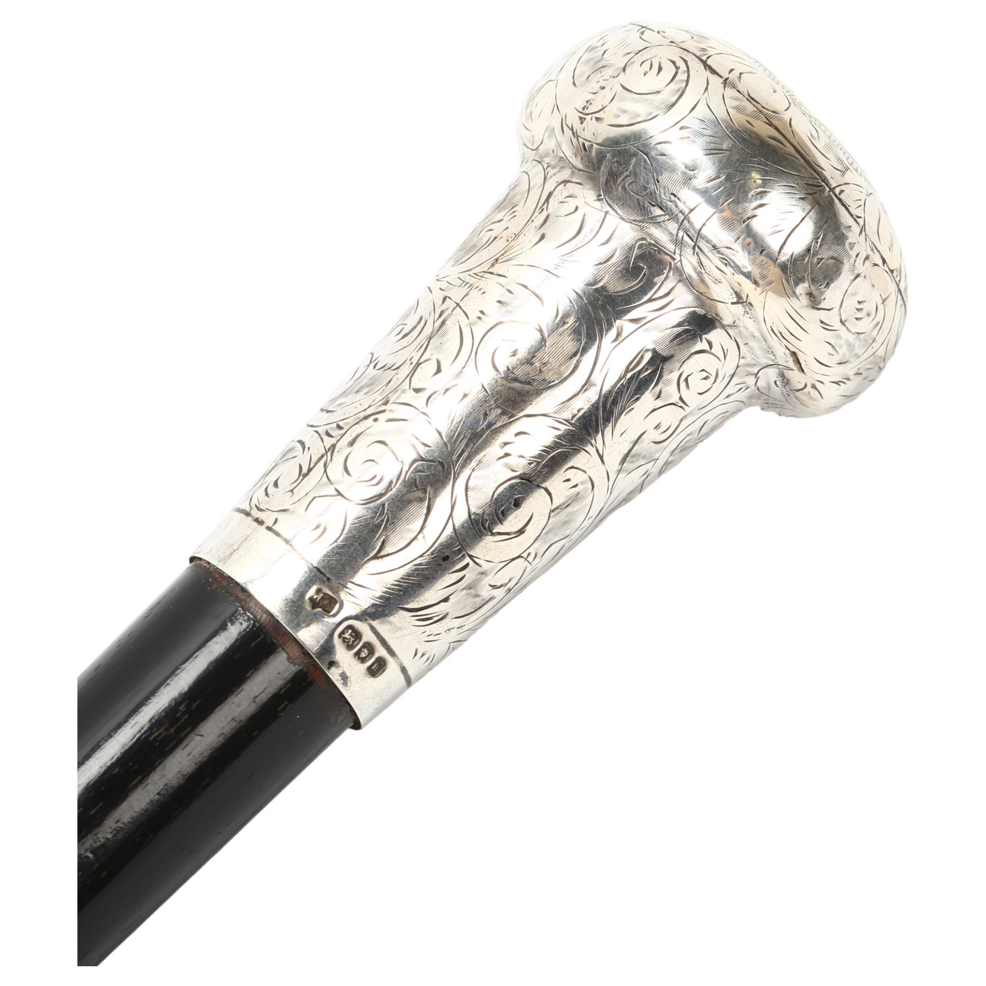 An Ebony walking cane with large hand engraved silver top, hallmarked London 1925/6, length 92cm