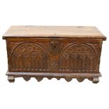 An 18th century oak coffer of small size, of plank construction, with chip carved Arcadian front,