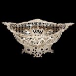 A Victorian silver table centre fruit bowl of oval form, floral embossed surround with shaped and