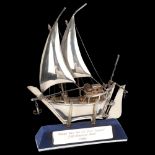 A Middle Eastern silver model dhow on stand, marked 925 silver, height 23cm, boxed