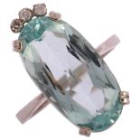 A modern 18ct white gold aquamarine and diamond dress ring, set with long oval mixed-cut