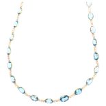 A 14ct gold blue topaz line necklace, set with oval mixed-cut topaz, length 50cm, 8.7g No damage