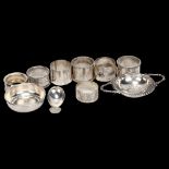 A group of various silver napkin rings, a George III silver caddy spoon, and a plated tea strainer