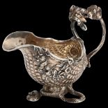 A fine quality George II cast silver cream jug, in the form of a nautilus shell on serpent base, the