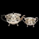 A Victorian silver teapot and matching sugar bowl, pierced fretwork surrounds on cast scrolled feet,