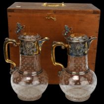 A fine pair of Victorian cut-glass and silver-gilt mounted Claret jugs, the relief cast mounts