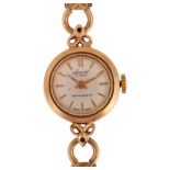 ACCURIST - a lady's 9ct gold mechanical bracelet watch, silvered dial with applied baton hour