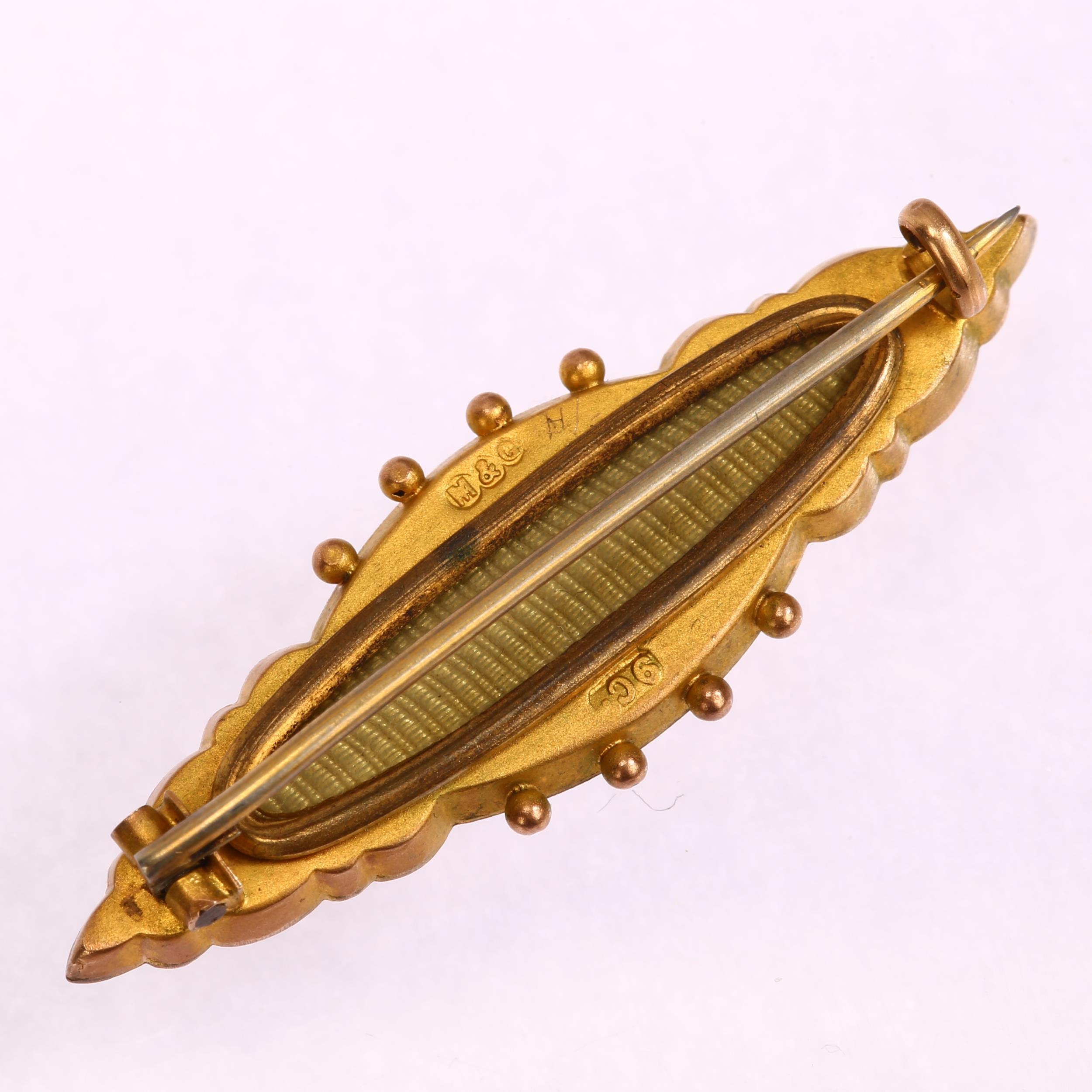 A Victorian 9ct gold garnet and pearl memorial brooch, maker M&G, length 40.7mm, 3.2g No damage or - Image 2 of 3