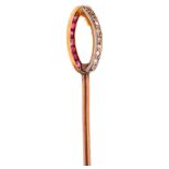 An Art Deco ruby and diamond ellipse? stickpin, unmarked gold settings with calibre-cut rubies and
