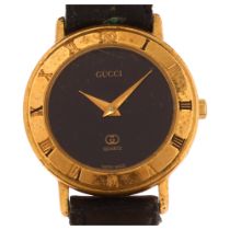 GUCCI - a lady's gold plated 3001L quartz wristwatch, circa 1986, black dial with Roman numeral