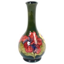 MOORCROFT - a green ground Hibiscus decorated tube-lined vase, signed to the base, H22.5cm Good