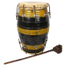 A barrel -shaped bongo drum, and carved wood club, drum height 44cm